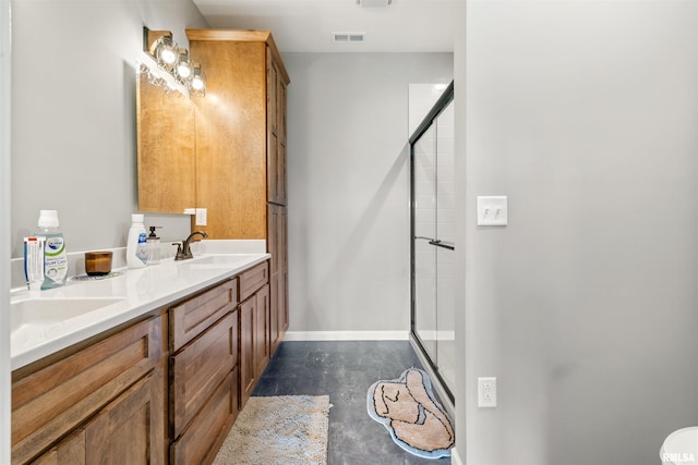 142 Oak Rd, Harrisburg, IL 62946 - bathroom with concrete floors, a stall shower, double vanity, and baseboards
