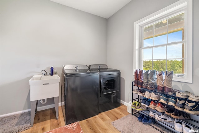 142 Oak Rd, Harrisburg, IL 62946 - laundry room featuring washer and clothes dryer, light wood finished floors, and baseboards