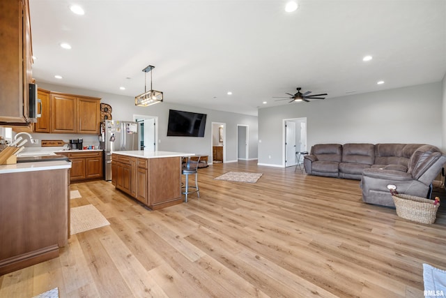 142 Oak Rd, Harrisburg, IL 62946 - kitchen featuring freestanding refrigerator, a center island, light countertops, brown cabinetry, and open floor plan