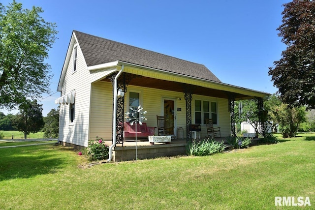 7059 Midway Rd, Metropolis, IL 62960 - bungalow-style home with covered porch, a front yard, and a shingled roof