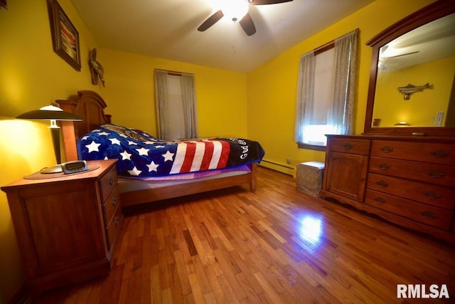 7059 Midway Rd, Metropolis, IL 62960 - bedroom with a baseboard heating unit, wood finished floors, and a ceiling fan