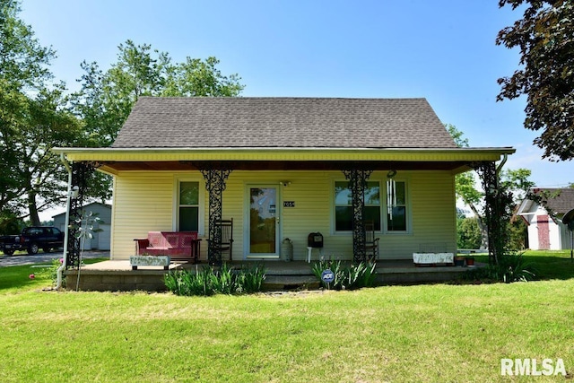 7059 Midway Rd, Metropolis, IL 62960 - bungalow-style home with covered porch, a front lawn, and a shingled roof