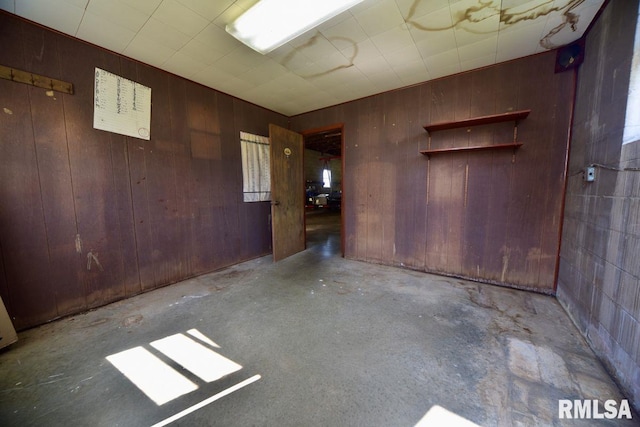 7059 Midway Rd, Metropolis, IL 62960 - empty room with concrete flooring and wood walls