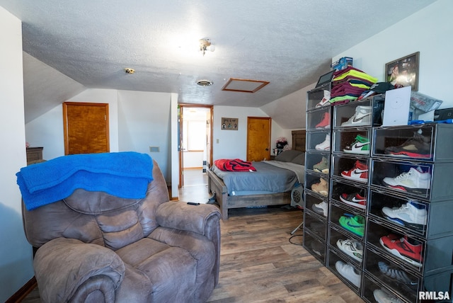 20040 Boulder Rd, Carlyle, IL 62231 - bedroom with attic access, wood finished floors, a textured ceiling, and vaulted ceiling