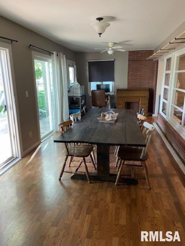 413 W Grant St, Pittsfield, IL 62363 - dining space featuring a ceiling fan, wood finished floors, and a fireplace