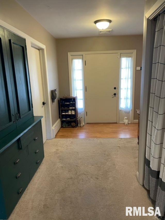 413 W Grant St, Pittsfield, IL 62363 - entrance foyer with light carpet, baseboards, and light wood finished floors
