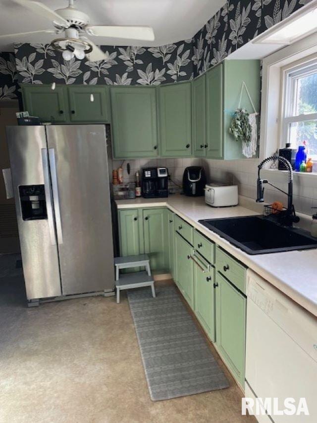 413 W Grant St, Pittsfield, IL 62363 - kitchen with green cabinets, stainless steel fridge with ice dispenser, white dishwasher, a sink, and light countertops