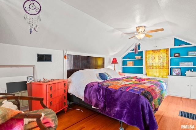 bedroom with lofted ceiling, wood finished floors, and ceiling fan