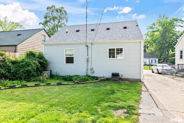 rear view of property featuring roof with shingles