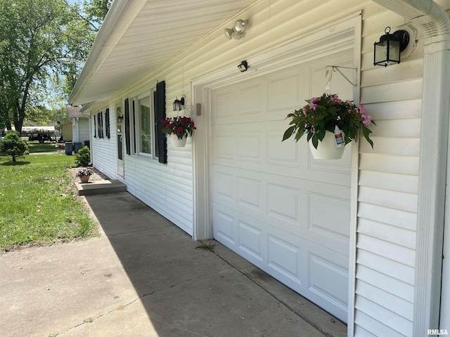 107 Locust Rd, Meredosia, IL 62665 - view of side of home with concrete driveway, an attached garage, and a yard