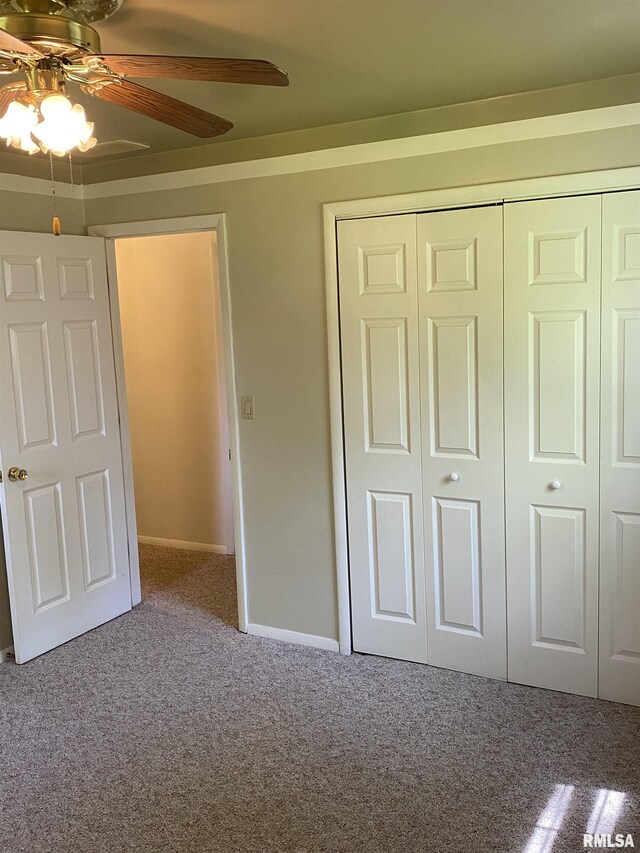 107 Locust Rd, Meredosia, IL 62665 - unfurnished bedroom with carpet floors, a closet, ceiling fan, and baseboards