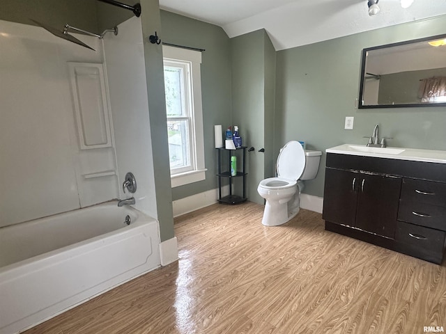 335 E S St, Mendon, IL 62351 - full bath featuring wood finished floors, toilet, shower / washtub combination, vanity, and vaulted ceiling