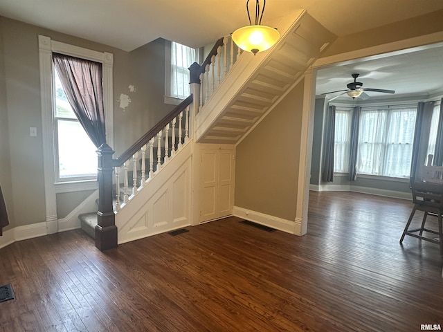 335 E S St, Mendon, IL 62351 - unfurnished living room featuring dark wood-style floors, plenty of natural light, stairway, and baseboards