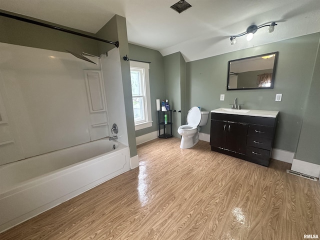 335 E S St, Mendon, IL 62351 - full bath with lofted ceiling, toilet, wood finished floors, washtub / shower combination, and vanity