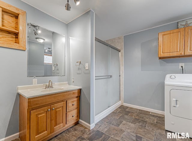 1507 4th St, Lincoln, IL 62656 - bathroom with washer / dryer, baseboards, a shower stall, vanity, and stone finish floors