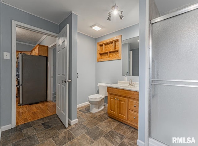 1507 4th St, Lincoln, IL 62656 - full bath with stone finish floors, vanity, a shower with door, baseboards, and toilet
