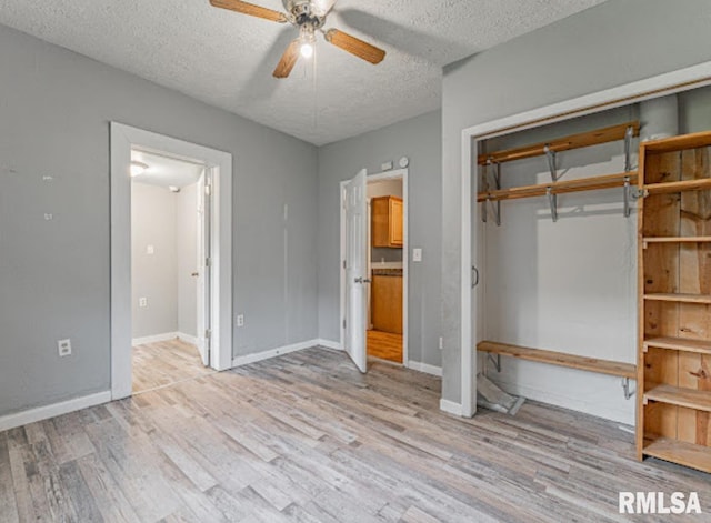 1507 4th St, Lincoln, IL 62656 - unfurnished bedroom featuring wood finished floors, a textured ceiling, ensuite bath, baseboards, and a ceiling fan