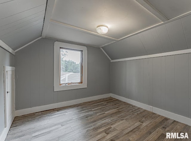 1507 4th St, Lincoln, IL 62656 - additional living space with wood finished floors, vaulted ceiling, and baseboards