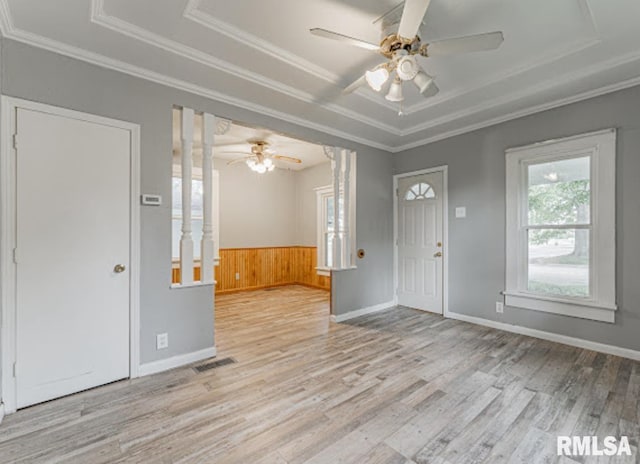 1507 4th St, Lincoln, IL 62656 - entrance foyer featuring a tray ceiling, ceiling fan, wood finished floors, crown molding, and wood walls