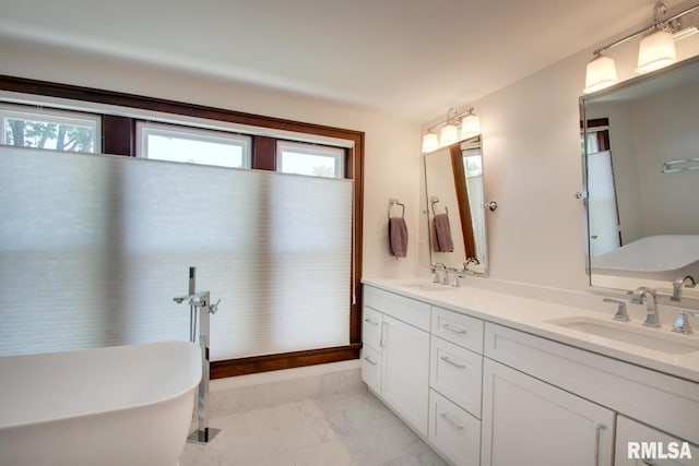 321 S 23rd St, Quincy, IL 62301 - bathroom with marble finish flooring, a soaking tub, and double vanity