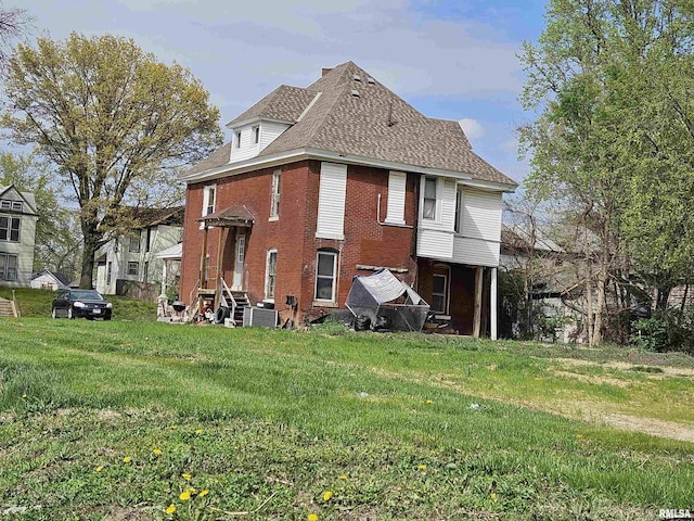 212 Chestnut St, Quincy, IL 62301 - back of house featuring brick siding, a yard, entry steps, and cooling unit