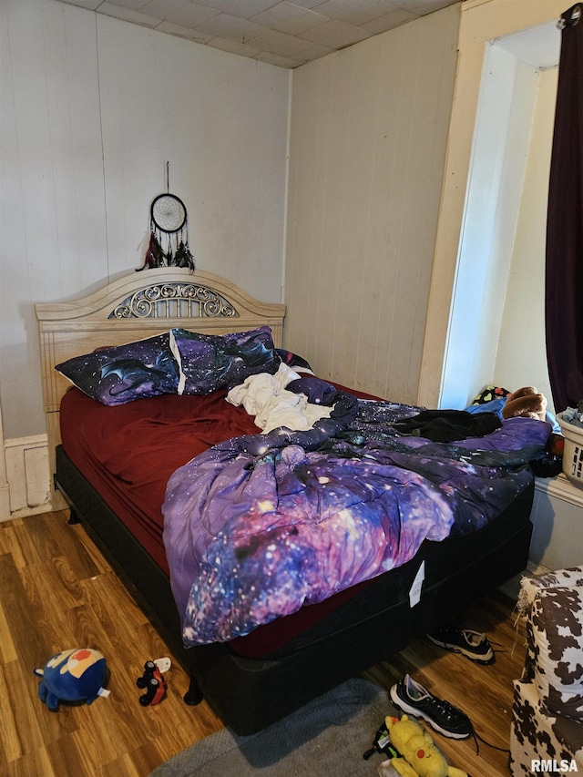 212 Chestnut St, Quincy, IL 62301 - bedroom featuring wood finished floors and wooden walls