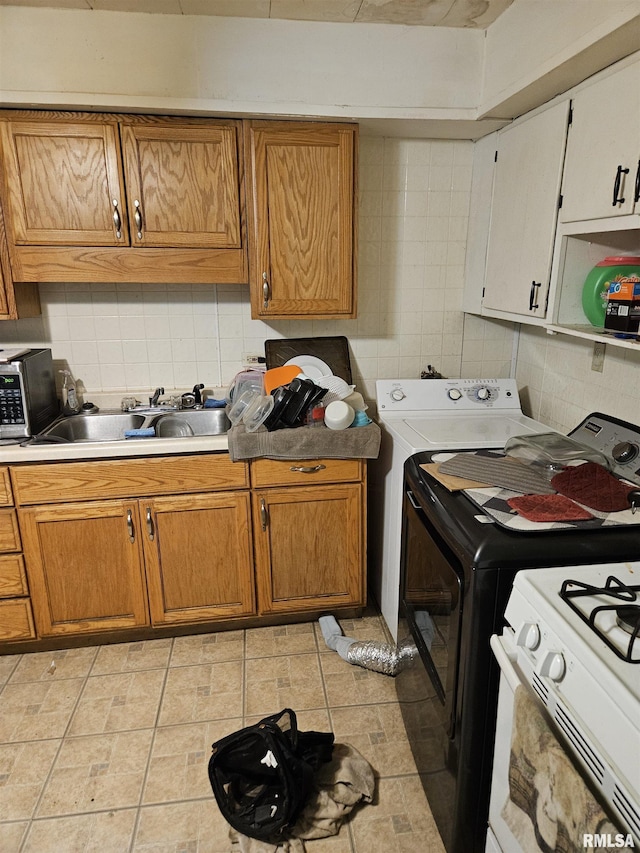 212 Chestnut St, Quincy, IL 62301 - kitchen with decorative backsplash, stainless steel microwave, a sink, and light countertops