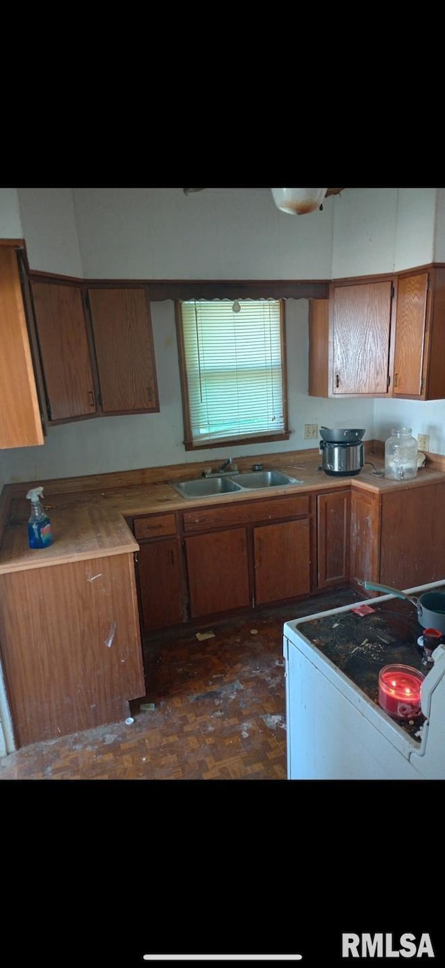 1360 Oak St, Hamilton, IL 62341 - kitchen featuring electric stove, a sink, brown cabinets, and light countertops