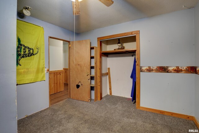 305 E Clay St, Pleasant Hill, IL 62366 - unfurnished bedroom featuring carpet flooring, a wainscoted wall, a textured ceiling, and a ceiling fan