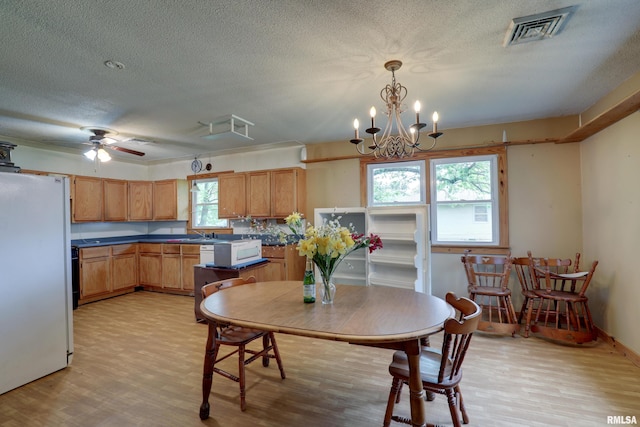 305 E Clay St, Pleasant Hill, IL 62366 - dining room featuring light wood-style floors, a textured ceiling, ceiling fan, and a chandelier