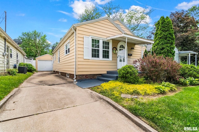 1622 W Cook St, Springfield, IL 62704 - view of front of property featuring concrete driveway, a detached garage, an outdoor structure, and central air condition unit