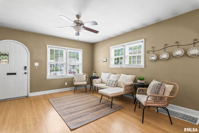 1622 W Cook St, Springfield, IL 62704 - living area with light wood finished floors, a ceiling fan, and baseboards
