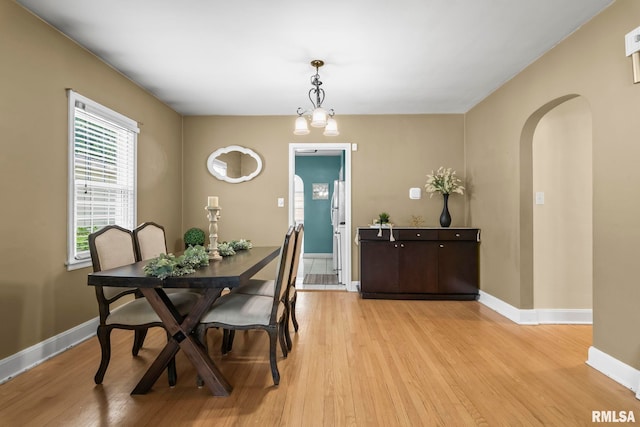 1622 W Cook St, Springfield, IL 62704 - dining area with arched walkways, light wood-style flooring, and baseboards