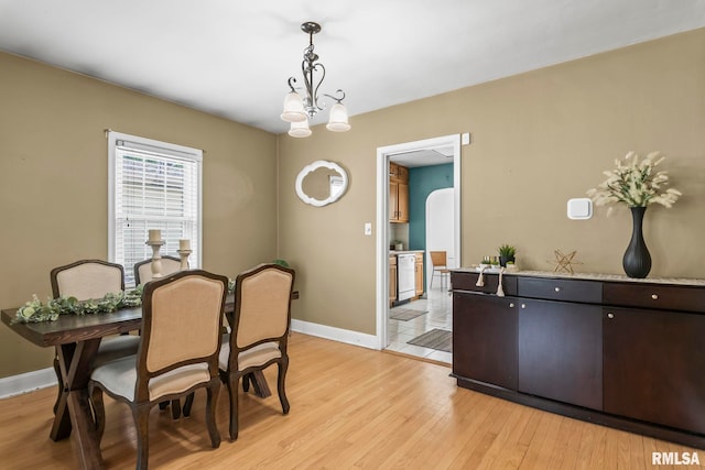 1622 W Cook St, Springfield, IL 62704 - dining room with baseboards, light wood-style floors, and a chandelier