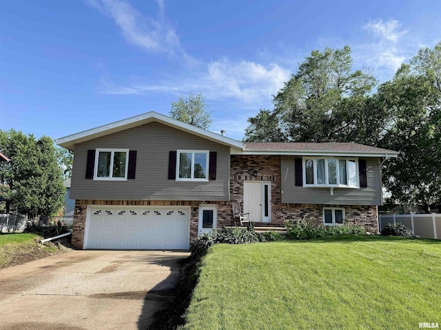 1666 Outrigger Rd, Galesburg, IL 61401 - bi-level home featuring an attached garage, driveway, and brick siding