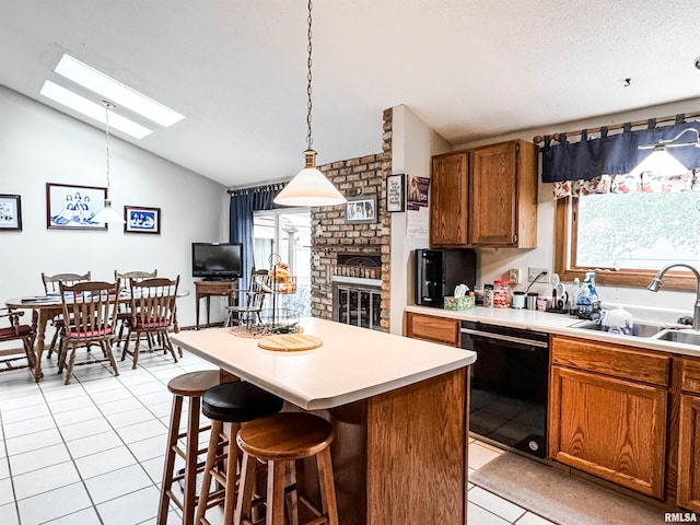 1666 Outrigger Rd, Galesburg, IL 61401 - kitchen featuring vaulted ceiling, black dishwasher, a sink, a skylight, and light tile patterned floors