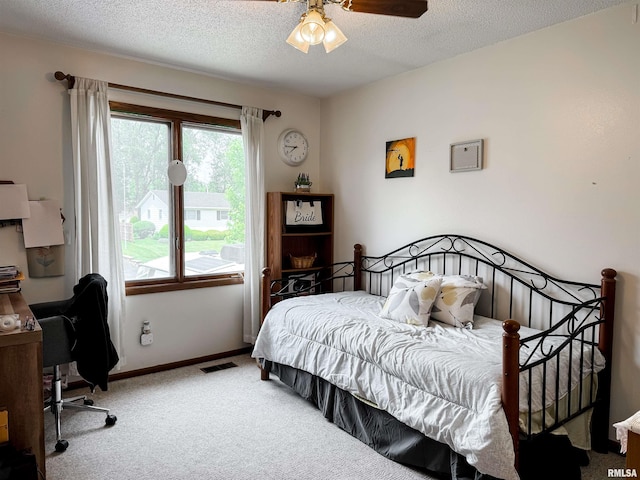 1666 Outrigger Rd, Galesburg, IL 61401 - bedroom featuring carpet floors, a textured ceiling, baseboards, a desk, and ceiling fan