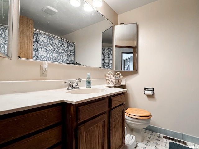1666 Outrigger Rd, Galesburg, IL 61401 - bathroom featuring vanity, baseboards, and toilet