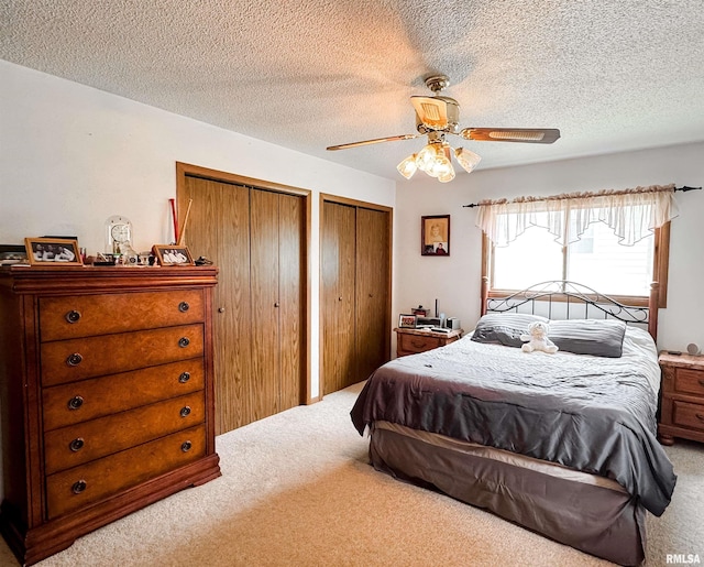 1666 Outrigger Rd, Galesburg, IL 61401 - carpeted bedroom with multiple closets, a ceiling fan, and a textured ceiling