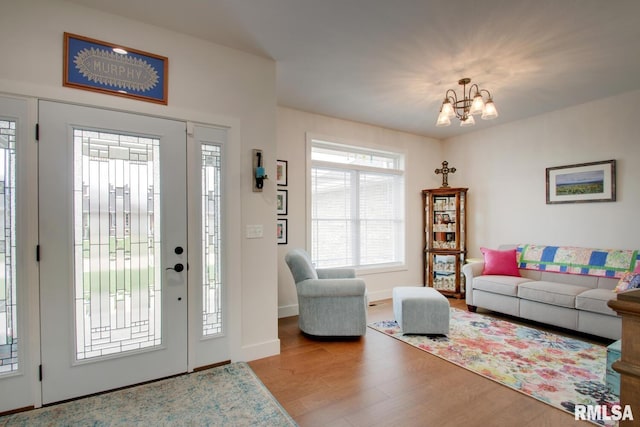 4619 Trinity Lakes Dr, Quincy, IL 62305 - entryway featuring a chandelier, wood finished floors, and baseboards