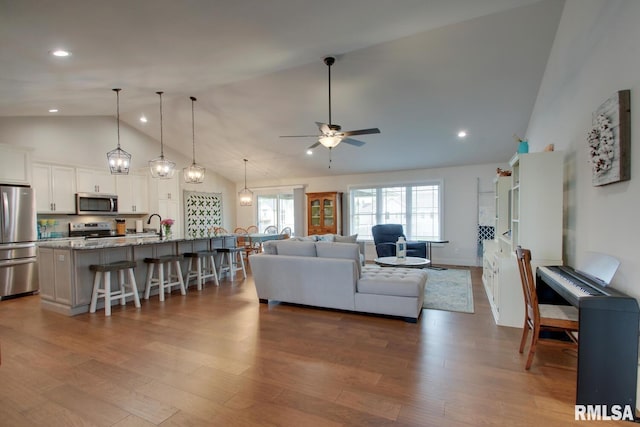4619 Trinity Lakes Dr, Quincy, IL 62305 - living room featuring high vaulted ceiling, ceiling fan, dark wood-style floors, and recessed lighting