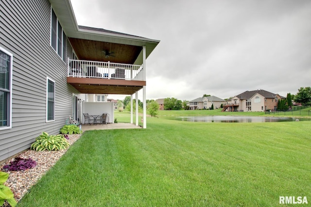 4619 Trinity Lakes Dr, Quincy, IL 62305 - view of green lawn with a patio area, a water view, a balcony, and a residential view