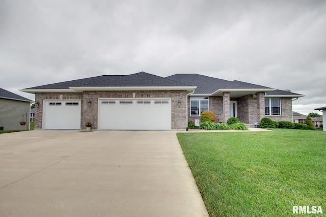 4619 Trinity Lakes Dr, Quincy, IL 62305 - view of front facade with a garage, concrete driveway, a front lawn, and brick siding