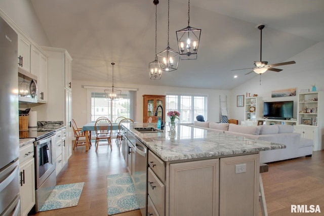 4619 Trinity Lakes Dr, Quincy, IL 62305 - kitchen featuring a sink, appliances with stainless steel finishes, lofted ceiling, a ceiling fan, and a chandelier