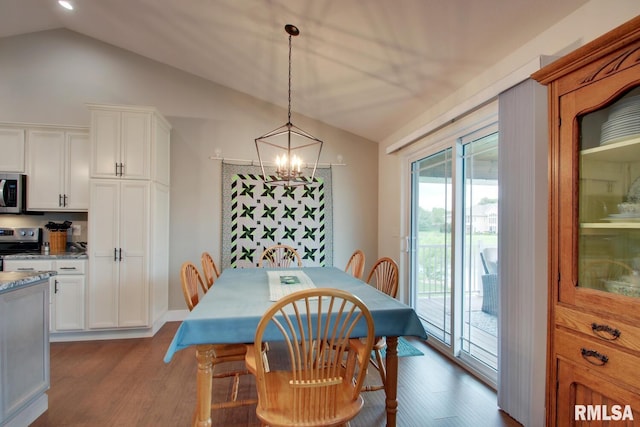 4619 Trinity Lakes Dr, Quincy, IL 62305 - dining area featuring vaulted ceiling, wood finished floors, and a chandelier