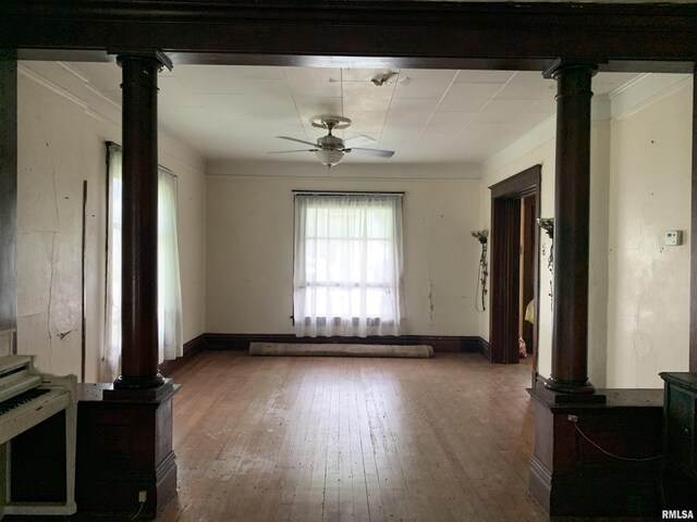 545 Bainbridge St, Barry, IL 62312 - unfurnished living room featuring decorative columns, a ceiling fan, wood-type flooring, ornamental molding, and baseboards