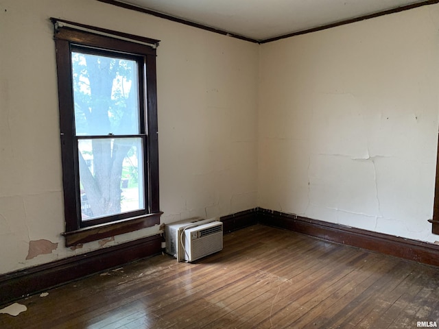 545 Bainbridge St, Barry, IL 62312 - unfurnished room with ornamental molding, wood-type flooring, and a wall mounted AC