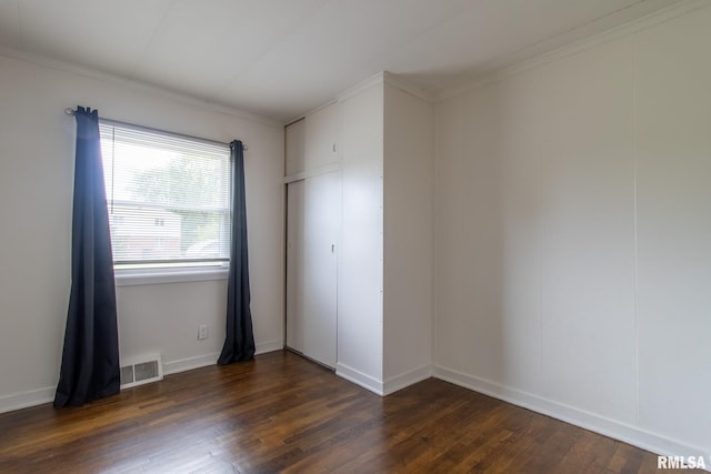 1520 W Losey St, Galesburg, IL 61401 - unfurnished bedroom with dark wood-style flooring, ornamental molding, and baseboards