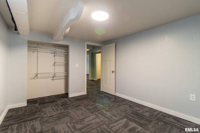 1520 W Losey St, Galesburg, IL 61401 - unfurnished bedroom featuring dark colored carpet, baseboards, and a closet
