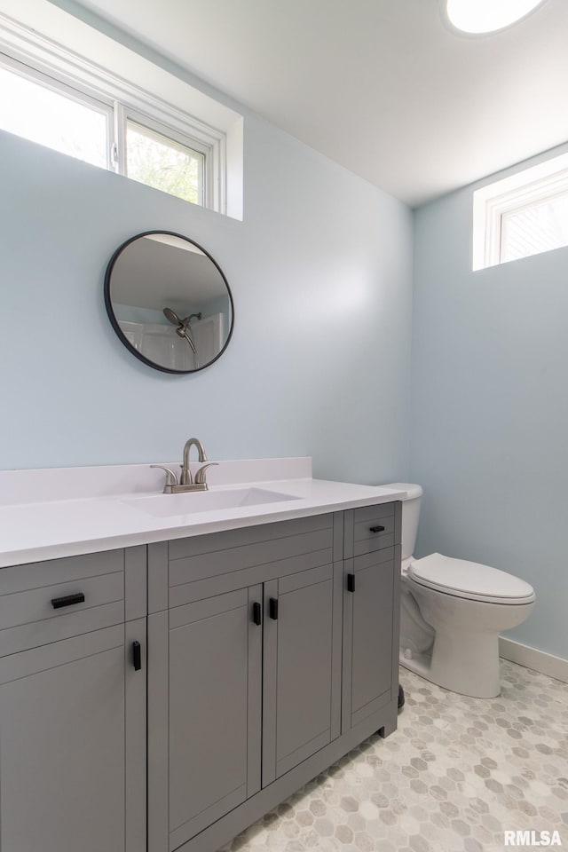 1520 W Losey St, Galesburg, IL 61401 - bathroom featuring vanity, plenty of natural light, toilet, and tile patterned floors